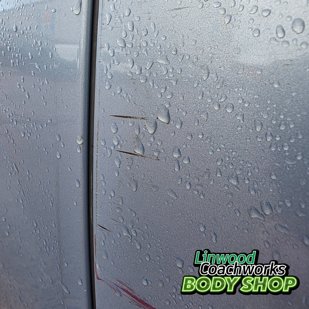 Close up scratch damage on car panel before paint matching repair Paisley