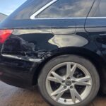 Black Audi with rear panel paint damage at Linwood Coachworks bodyshop Linwood